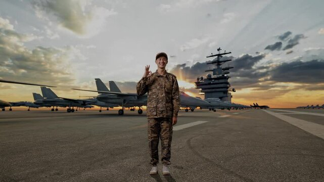 Full Body Of Asian Man Soldier Smiling And Showing Okay Gesture To Camera While Standing On Aircraft Carrier