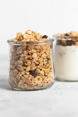 granola with chocolate, yogurt with granola in a glass jar