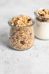 granola with chocolate, yogurt with granola in a glass jar