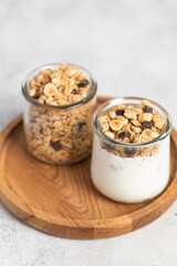 granola with chocolate, yogurt with granola in a glass jar