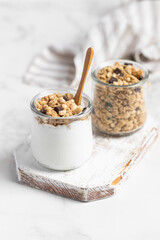 granola with chocolate, yogurt with granola in a glass jar