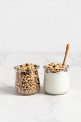 granola with chocolate, yogurt with granola in a glass jar