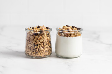 granola with chocolate, yogurt with granola in a glass jar