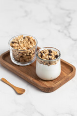 granola with chocolate, yogurt with granola in a glass jar