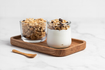 granola with chocolate, yogurt with granola in a glass jar