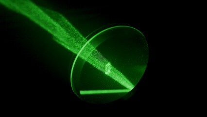 Neon green laser light beam flashing in darkness, close up projector lamp with light ray shining...