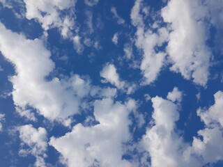 Fototapeta premium White fluffy clouds floating on blue sky background