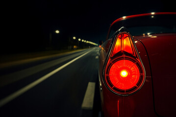 close up of a car tail light on a night street