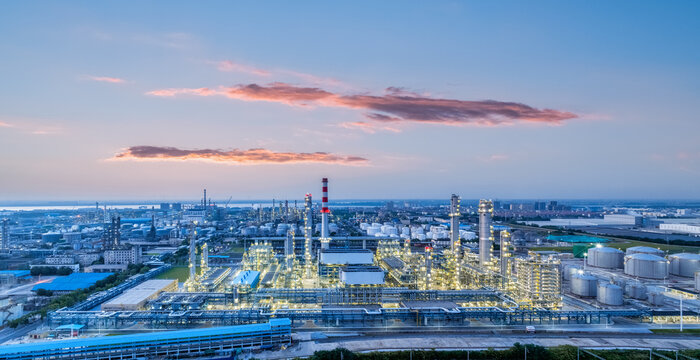 oil refinery against a sunset glow sky