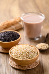 Organic rice milk in cup glass on wooden background, Alternative milk made from plant, non dairy