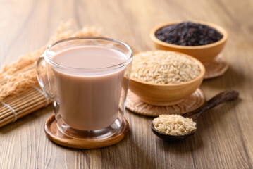 Organic rice milk in cup glass on wooden background, Alternative milk made from plant, non dairy