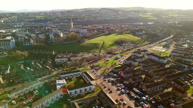 High advancing aerial of the Creggan area and Derry City Walls in Derry-Londonderry on a sunny day. Filmed in 4K, 60fps and in Rec709 color.