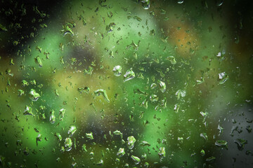 Effet de pluies sur vitre avec vert derrière. . 