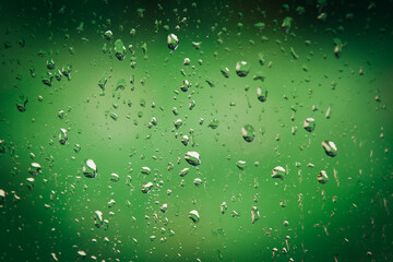 Effet de pluies sur vitre avec vert derrière. . 