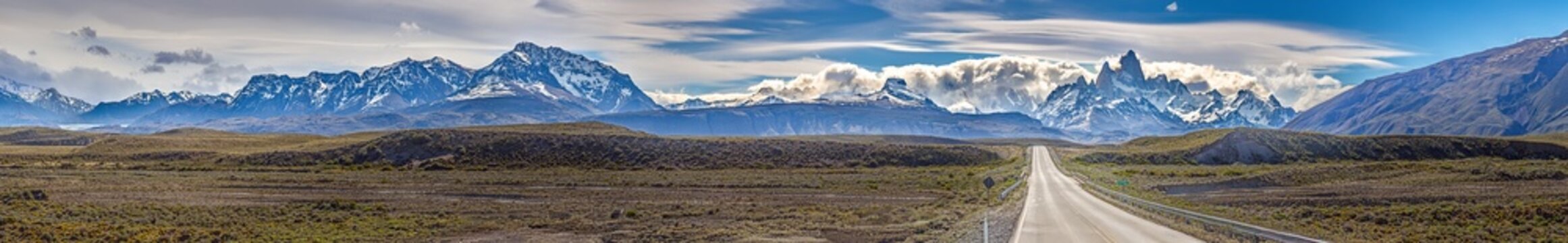 Road leading to El Chalten surrounded by stunning mountains and dramatic skies in Patagonia