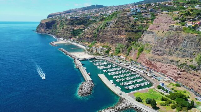 Aerial view of the beach and harbor in Calheta, Aerial view of the cliff near Calheta, a municipality on the southwest coast of the Portuguese island of Madeira