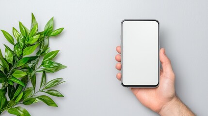 Hand Holding Smartphone With Blank Screen And Plant