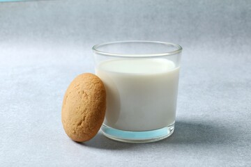 Glass of milk with cookies on table