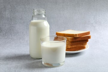 Glass of milk with bread on the table