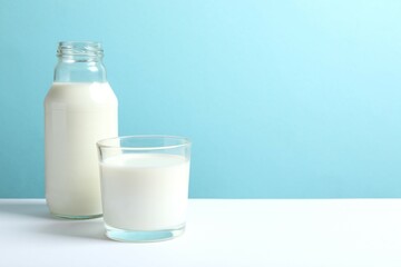 Glass of milk and bottle on the table 