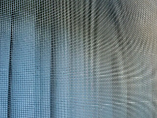 Close-Up of Mesh Screen with Subtle Background Patterns and Textures