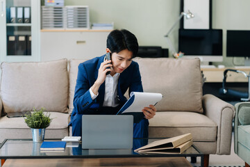 Male businessman talk mobile phones and working on laptop computers, online business, work from home, teleworking concept.