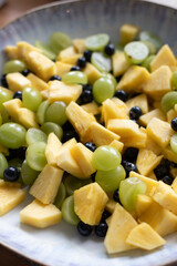 Delicious fruit salad with pineapple, blueberries and grapes
