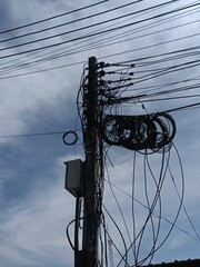 Electric pole, wire, cable,power, line,technology ,electricity, and blue sky background in Thailand
