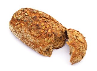 One loaf of bread with pumpkin seeds is broken in two.