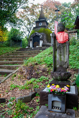 Ueno Daibutsu pagoda at Great Buddha Hill with a Jizo buddha statue in Ueno Park, Tokyo, Japan.