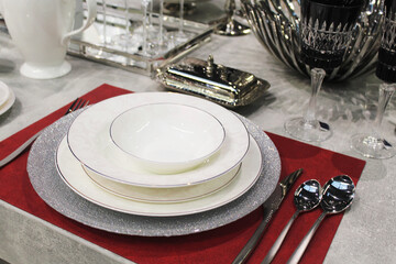 beautiful table setting, empty beautiful ceramic plates and cutlery on the table