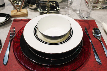beautiful table setting, empty beautiful ceramic plates and cutlery on the table