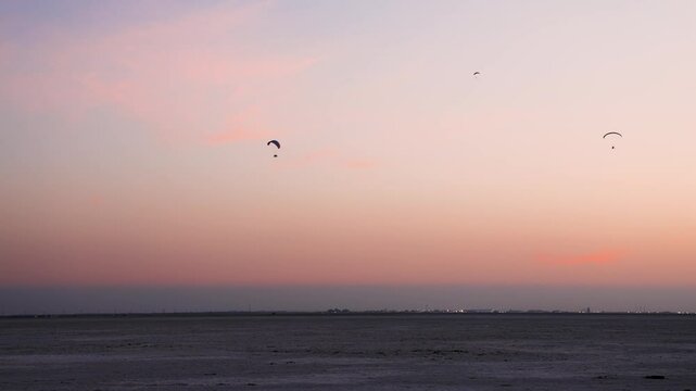 para motors flying in pristine sunset dramatic orange sky at dusk