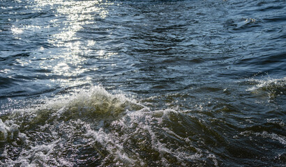 Water surface with ripples and sunlight reflections