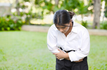 South Asian Indian woman with stomach ache, concept image of menstrual period cramp, abdominal...