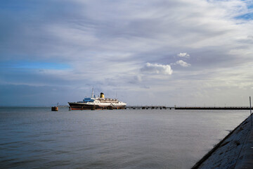 Luxury Cruise Ship Docked at Scenic Waterfront On A Clear Day