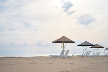 Beachside Tranquility With Umbrellas and Loungers by the Ocean