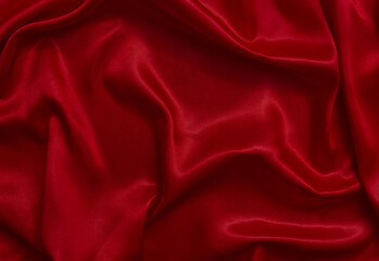 Obraz premium The top view of the red satin surface looks luxurious and beautiful. with sparkling waves Abstract background design copy space Card or banner (blurred or blurry)