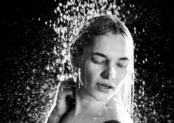 Playful Moments Under a Water Stream: A Portrait of a Young Woman Capturing Emotions and Mood