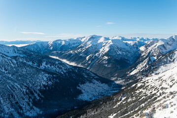 Tatra mountains at winter time. View of the white snow-capped peaks, frosty winter mountains. Kasprowy Wierch, High Tatra, Poland, Europe.
