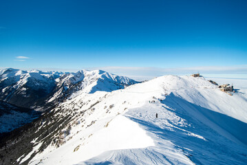 Tatra mountains at winter time. View of the white snow-capped peaks, frosty winter mountains. Kasprowy Wierch, High Tatra, Poland, Europe.