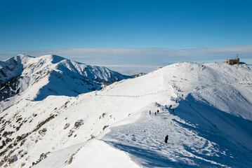 Tatra mountains at winter time. View of the white snow-capped peaks, frosty winter mountains. Kasprowy Wierch, High Tatra, Poland, Europe.