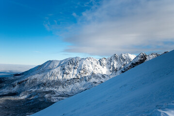 Tatra mountains at winter time. View of the white snow-capped peaks, frosty winter mountains. Kasprowy Wierch, High Tatra, Poland, Europe.