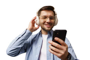 Man enjoying music with headphones while using smartphone in a bright setting
