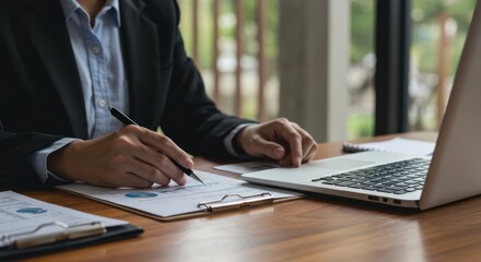 Businesswoman Analyzing Financial Data on Laptop
