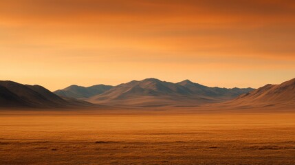 A serene desert landscape with rolling mountains under a warm, orange sky, creating a tranquil and picturesque scene.