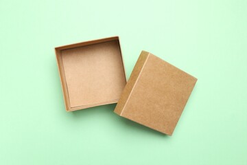 Open cardboard box on green background