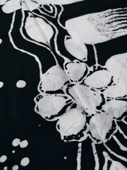 pattern and background of black fabric with white floral motifs