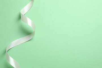 Beautiful silk ribbon on green background