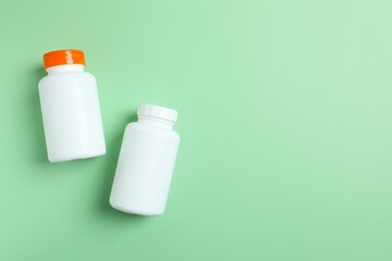 White bottles on a green background